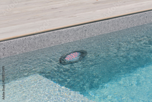 Swimming pool with underwater light LED near wooden deck photo