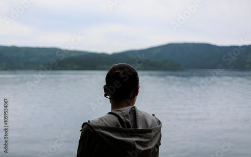 The silhouette of a woman wearing headphones. photo