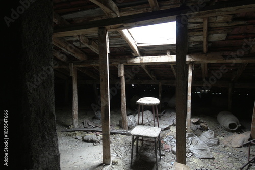 Abandoned Attic with Sunlight Filtering Through Roof photo