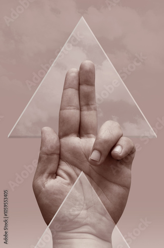 A hand of a man and two glass triangles photo