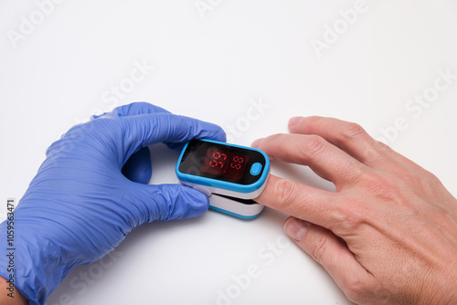 Принти на полотні Doctor measures the patient's pulse and oxygen saturation to a patient