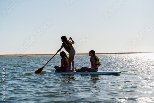 Girls Paddleboarding on Calm Ocean
