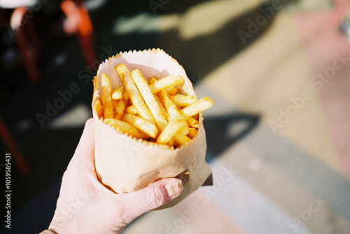 Hand holding bag of chips photo