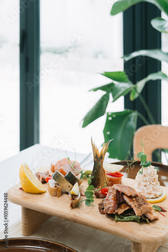 Wooden board with assorted seafood and lemon garnish photo