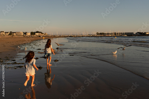 Kids playing on Beach at sunset photo