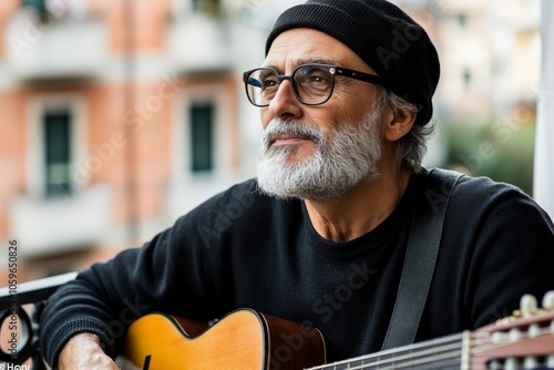 An older man with a guitar sits thoughtfully, gazing into the distance, conveying a sense of nostalgia and wisdom, while capturing a peaceful musical moment. photo