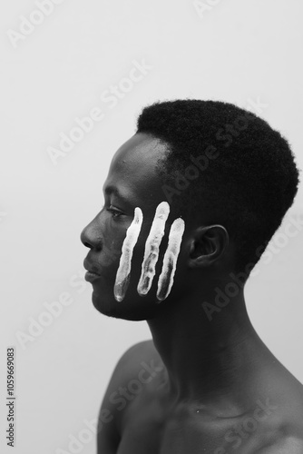 Portrait of Model with white paint strokes on his face  photo