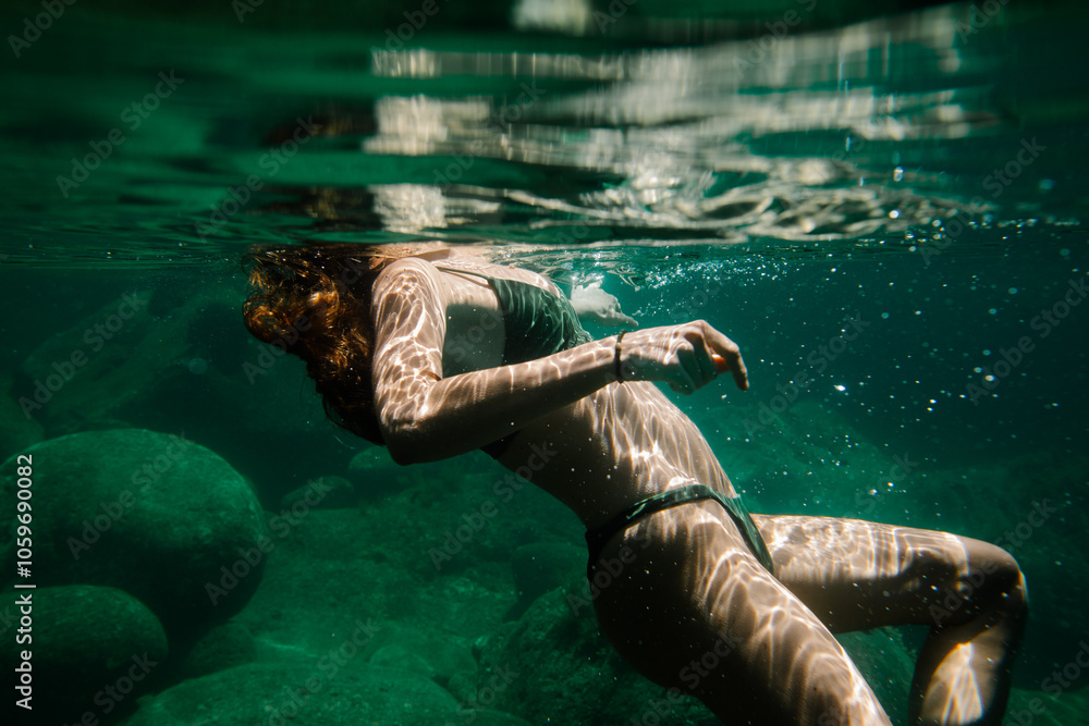 © Adrian Rodd/Stocksy - Underwater medium shot of an unknown lady floating peacefully © Adrian Rodd/Stocksy - Underwater medium shot of an unknown lady floating peacefully