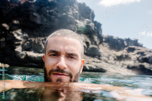 Selfie of a traveler enjoying a dip in fresh water in a natural pool photo