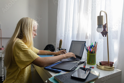 Student is math equations on laptop at home photo