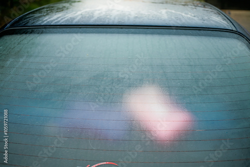 close-up view of sweaty rear defogger car with dew all over tempered glass window photo