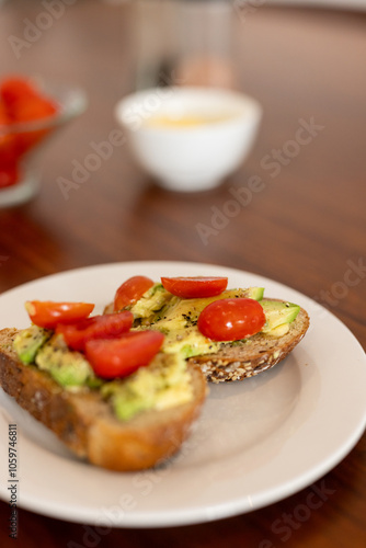 Avocado toast with cherry tomatoes on plate, perfect for healthy breakfast, at home photo