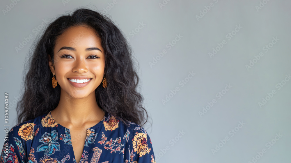 Fototapeta premium Afro woman in traditional batik cloth isolated on gray copy space