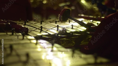 Close up man playing Gamelan, traditional instrumental from java indonesia at wayang or puppet theatre photo