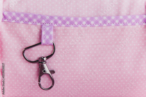 Organizer bag for storing needlework tools. Pink and purple bag with a handmade tag. Violet-pink soft fabric. photo