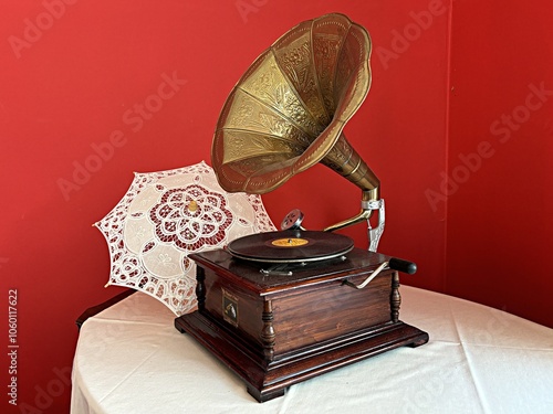 Old gramophone and umbrella on the table