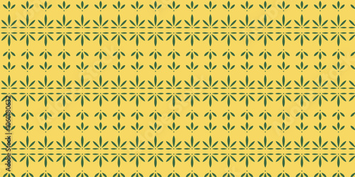 Seamless pattern with green cassava leaf motif on yellow background