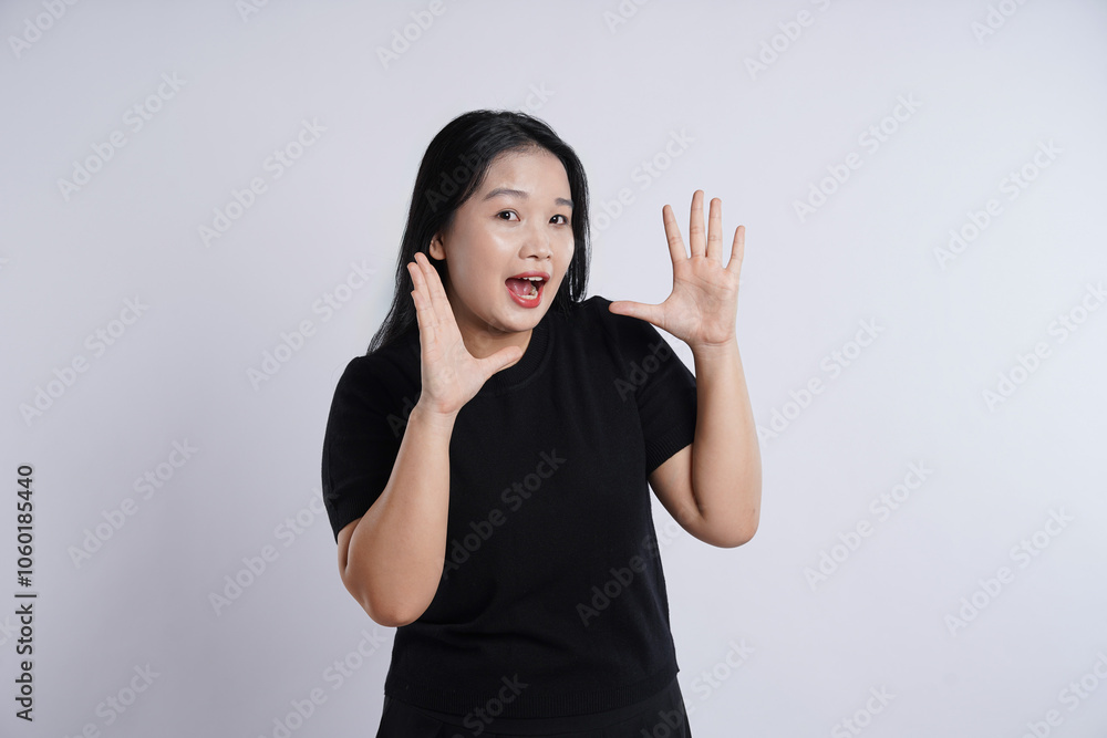 Young, obese, plus-sized Asian girl wearing black t-shirt posing against plain white background Young, obese, plus-sized Asian girl wearing black t-shirt posing against plain white background
