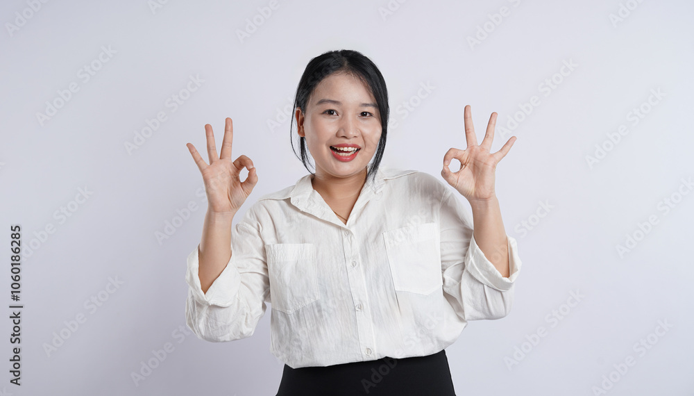 Young, obese, plus-sized Asian office worker wearing white shirt posing on plain white background Young, obese, plus-sized Asian office worker wearing white shirt posing on plain white background