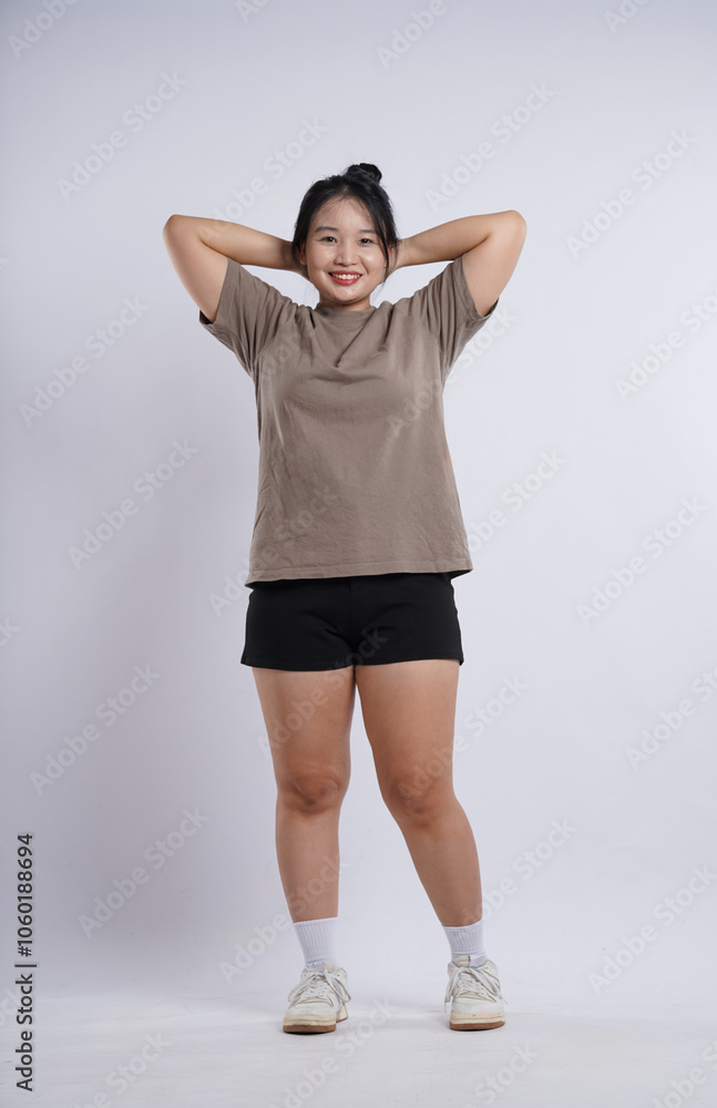 Fat Asian girl exercising on plain white background Fat Asian girl exercising on plain white background