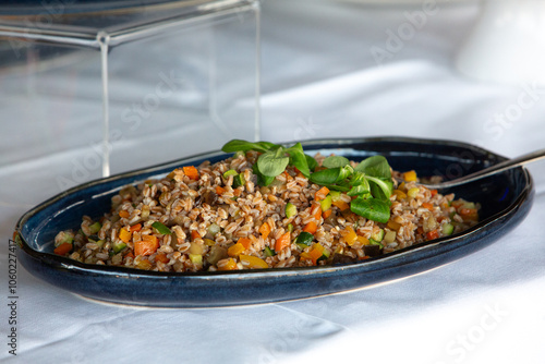 Spelled salad with vegetables and lamb's lettuce on elegant serving platter