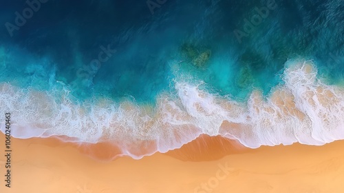 Aerial view of foamy ocean waves breaking on a sandy beach.