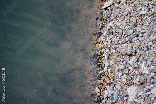 Fotografie river stones, rocks on the edge of the river