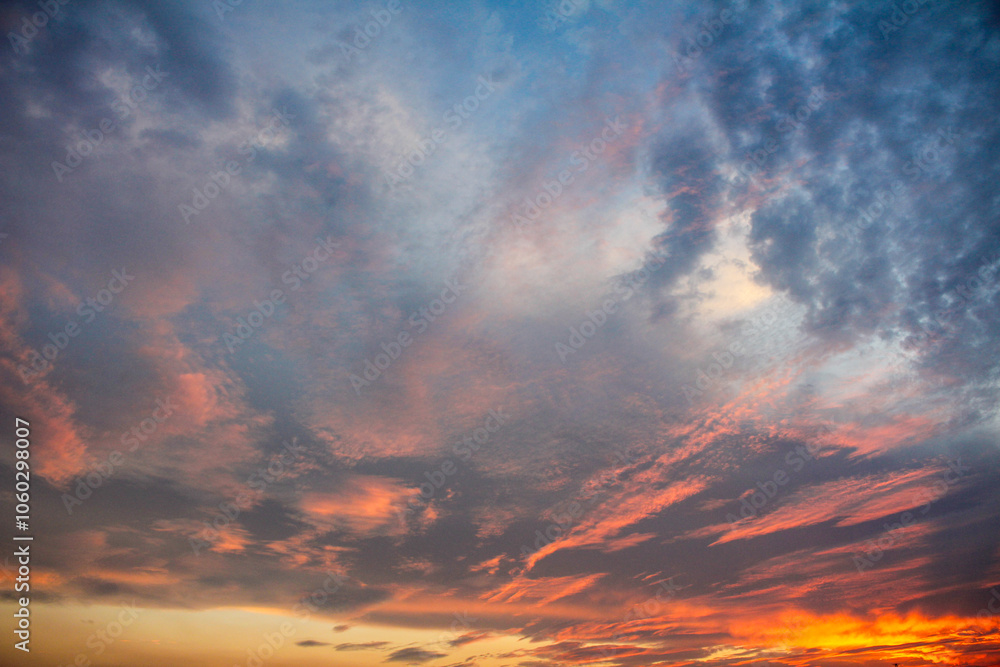 Sunset or sunrise. Dramatic majestic scenery sunset. Sky with clouds in sunset sky light background. Sunrise with clouds in various shapes. Calm sunset sky and sun through clouds over. Sunset or sunrise. Dramatic majestic scenery sunset. Sky with clouds in sunset sky light background. Sunrise with clouds in various shapes. Calm sunset sky and sun through clouds over.