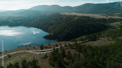 Nature of western Serbia in early autumn on a sunny warm day, Zlatibor town popular among tourists. Aerial view from a drone of Lake Ribnichko, next to the cable car leading to Mount Tornik. photo