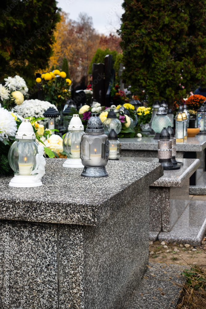 Graves with candles during the All Souls' Day celebration on November 1st. Photo taken during the day in natural light