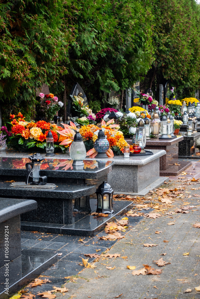 Graves with candles during the All Souls' Day celebration on November 1st. Photo taken during the day in natural light
