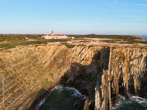 Aerial view of the Farol do Cabo Sardão lighthouse at the edge of the steep cliff. in Portugal