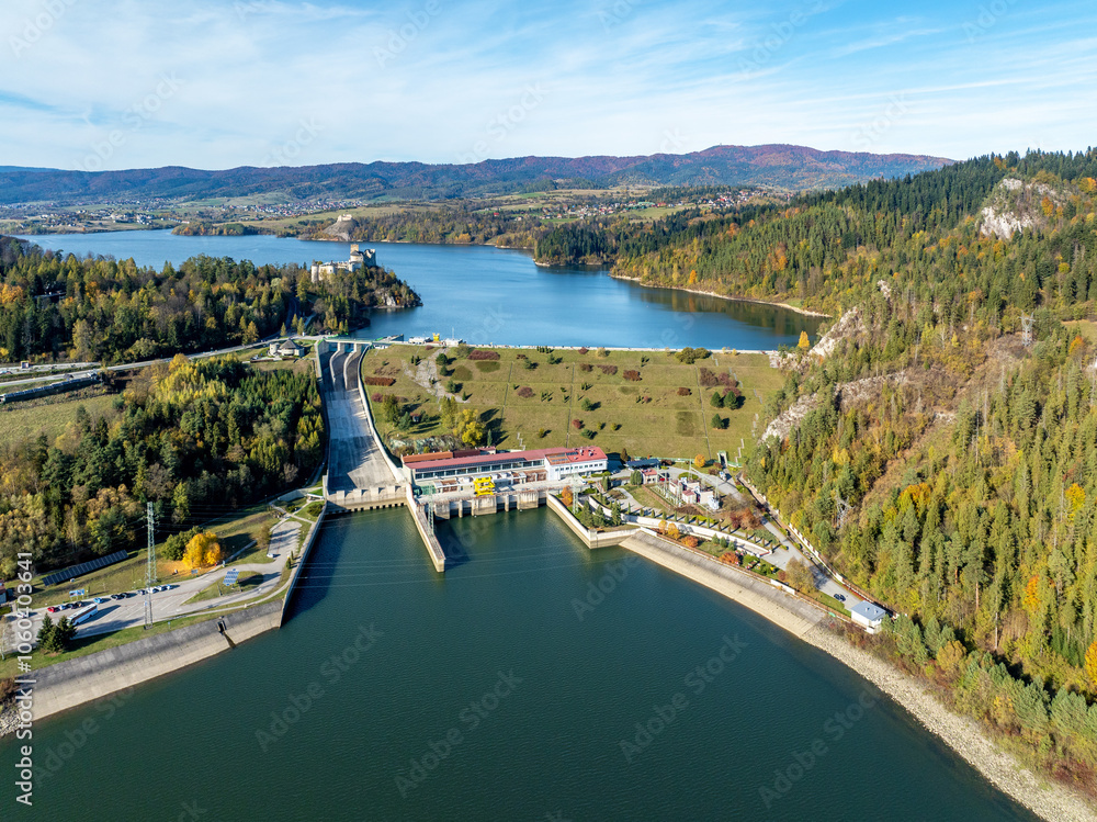 Poland. Niedzica ground dam on Dunajec River and hydroelectric power plant in fall. Czorsztyn lake, medieval Niedzica castle and far view of Czorsztyn castle. Pieniny and Gorce mountains. Aerial view