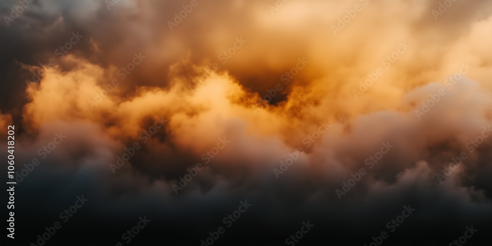 Dramatic clouds illuminated by sunset hues in fiery mix of orange and gold Dramatic clouds illuminated by sunset hues in fiery mix of orange and gold