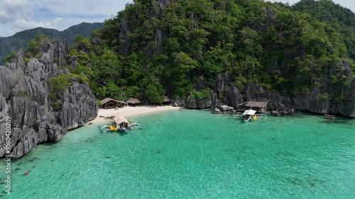 Mesmerizing Aerial View of a Small Lagoon with Boats in Turquoise Waters, Surrounded by Lush Mountains and Stunning Cliffs in the Philippines – High-Resolution 4K