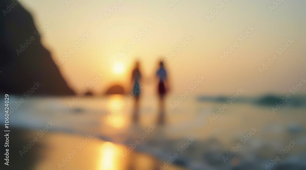 Blurred image of the silhouettes of a loving couple walking on water on the shore of a tropical island Blurred image of the silhouettes of a loving couple walking on water on the shore of a tropical island