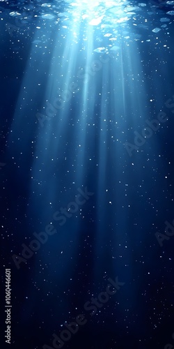 A serene underwater scene showcasing beams of sunlight piercing through deep blue waters, highlighting the tranquil beauty of the aquatic environment. photo