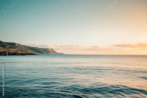 A serene sunset scene over the ocean on a cloudy day, perfect for travel or nature-themed projects. Beautiful simple AI generated image