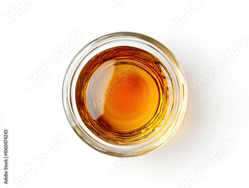 Overhead photograph of organic maple syrup in a glass