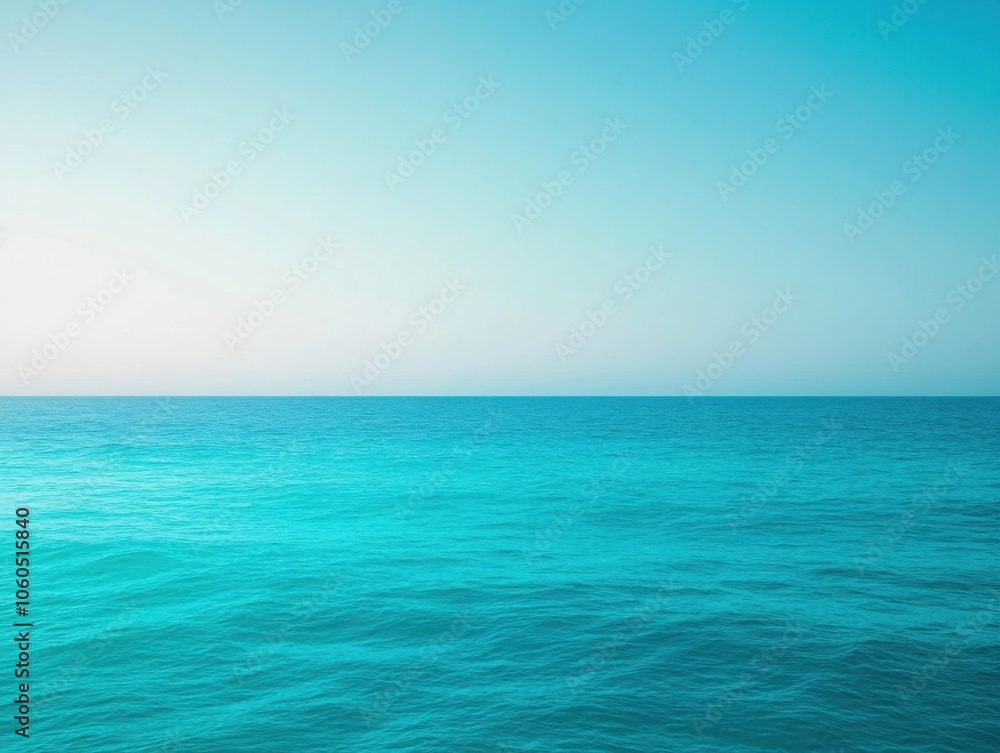 Obraz premium Serene ocean landscape with calm turquoise water under a clear blue sky.