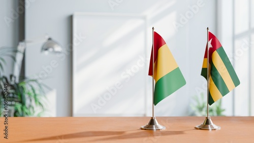 FLAGS OF GUINEA And TOGO ON TABLE photo