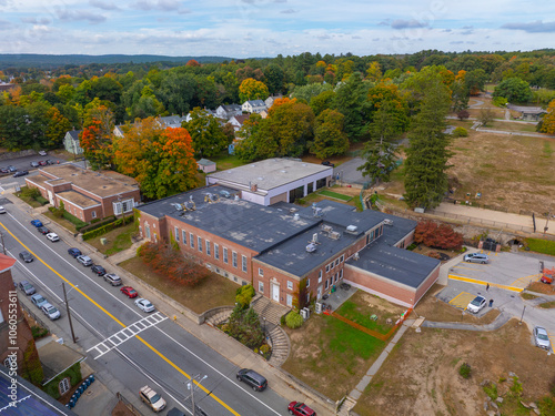 Whitin Community Center aerial view at 60 Main Street in fall with foliage in historic village of Whitinsville, town of Northbridge, Massachusetts MA, USA. 