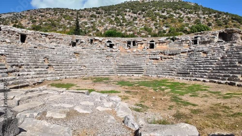 The originally Hellenistic theatre of Kaunos was built on the western slope of the Acropolis Hill. For the most part it rests on the rocky underground of the hill. photo