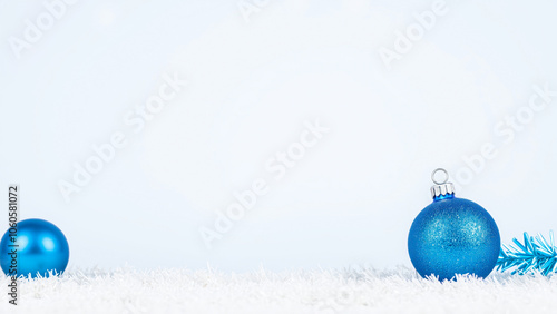 two blue ornaments on a white surface