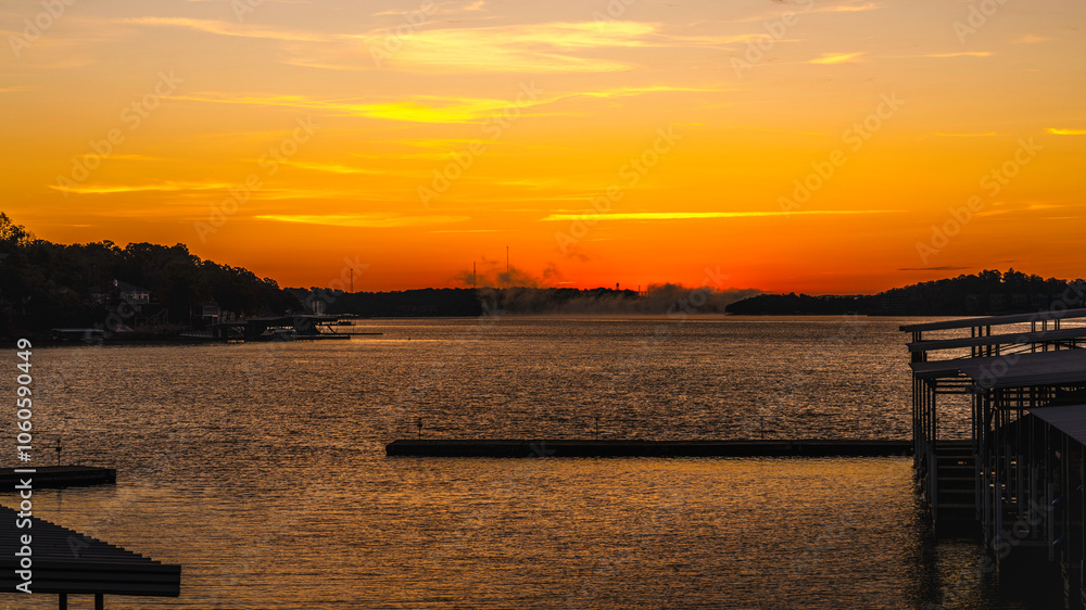 Fototapeta premium Sunrise over the marina at the Lake of the Ozarks with a dramatic cloudscape in Missouri, USA