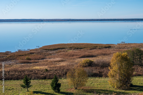 Aerial view from hill for suburb road, far hills, lake at sunny day in autumn. photo