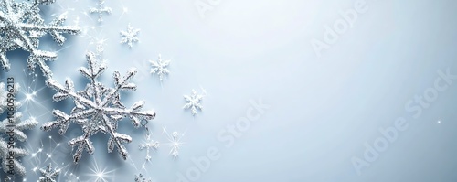 Flocons de neige étincelants sur fond bleu hivernal avec étoiles brillantes.