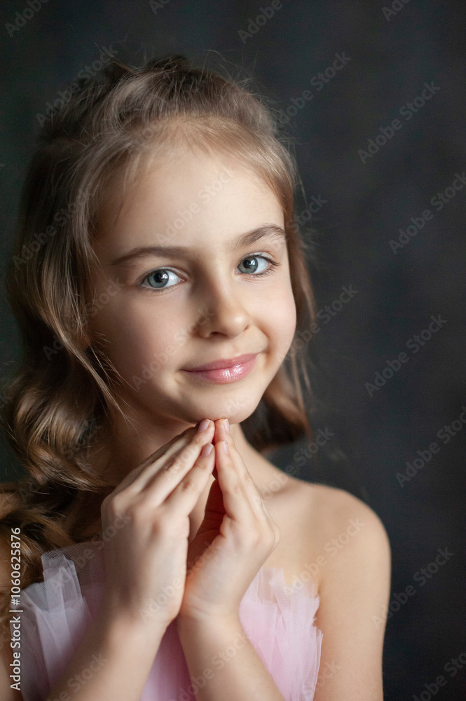 Close-up portrait of a young girl with beautifully styled hair, her hands gently folded as she dreams or makes a wish. Her soft expression and thoughtful gaze capture a magical, tender moment. Close-up portrait of a young girl with beautifully styled hair, her hands gently folded as she dreams or makes a wish. Her soft expression and thoughtful gaze capture a magical, tender moment.