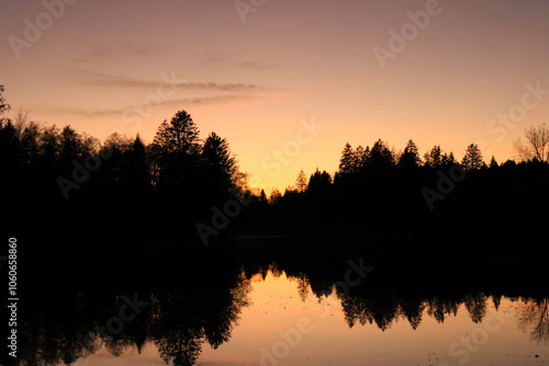 Beautiful sunset reflection with forest in a lake, Waldsee Lindenberg im Allgäu