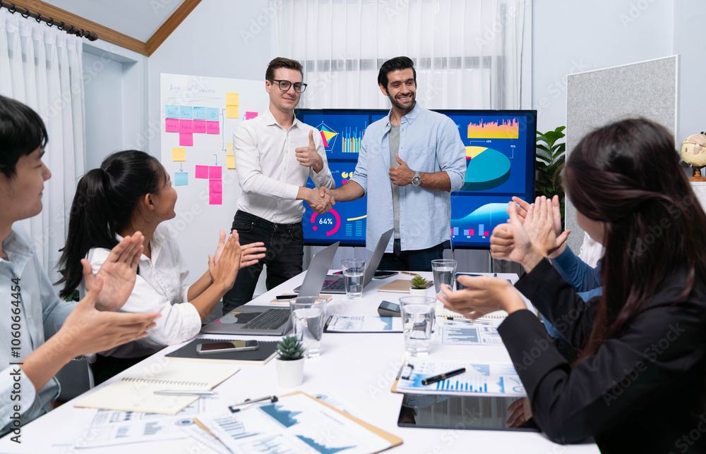 Analyst team leader shake hand with his colleague after successful data analysis meeting using FIntech software power with business intelligence or BI dashboard. Prudent Analyst team leader shake hand with his colleague after successful data analysis meeting using FIntech software power with business intelligence or BI dashboard. Prudent
